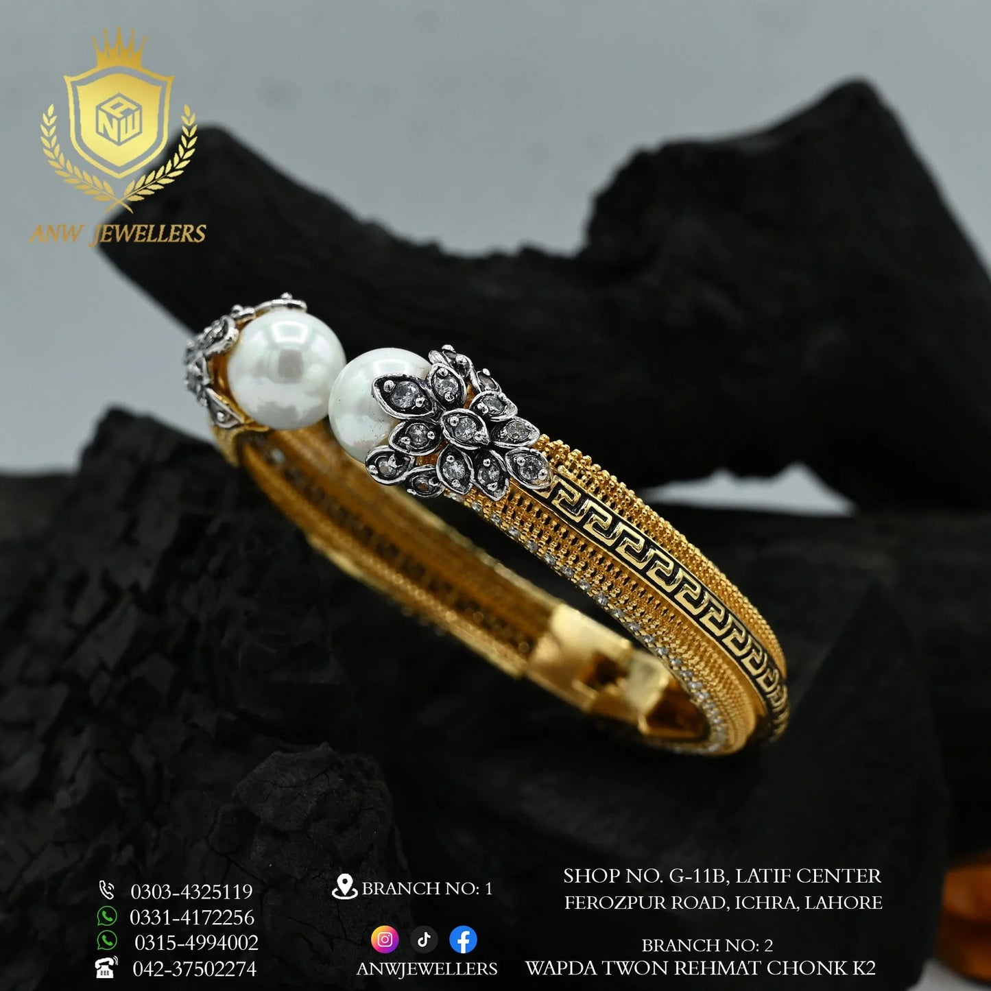 Gold bangles with pearl and diamond accents by ANW Jewellers on a black background