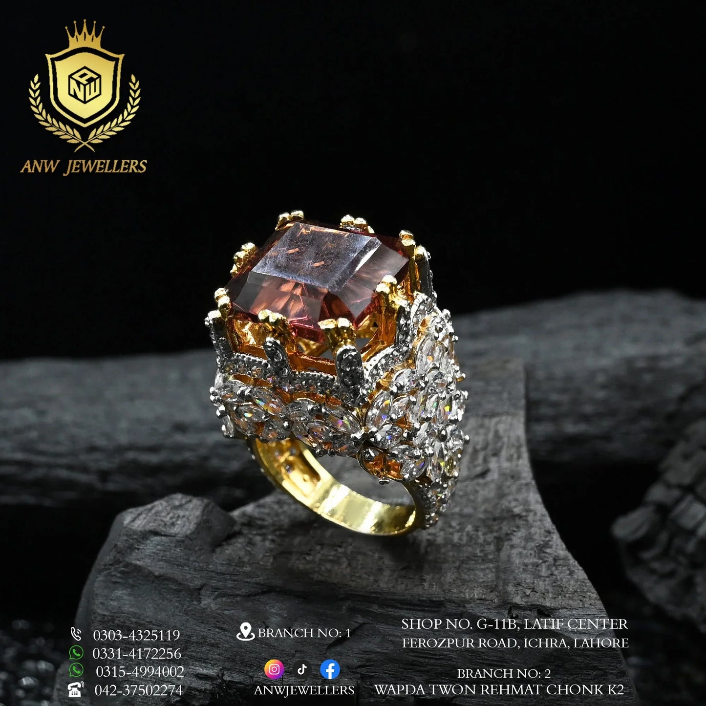 ANW Jewellers gold ring with large gemstone and diamond accents on dark background
