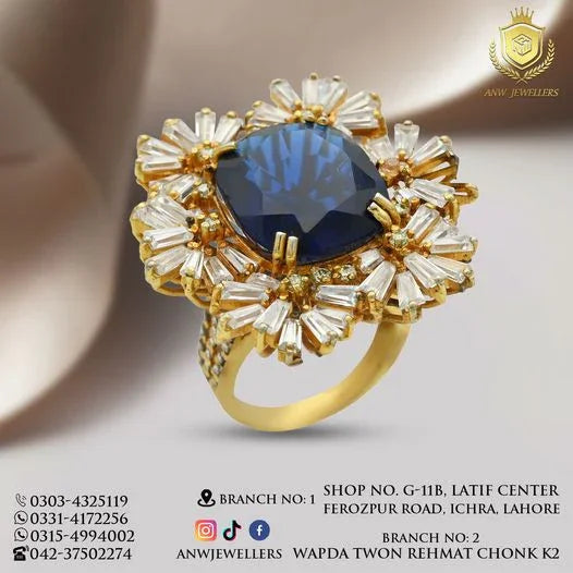 Gold ring with large blue gemstone and intricate diamond setting by ANW Jewellers.