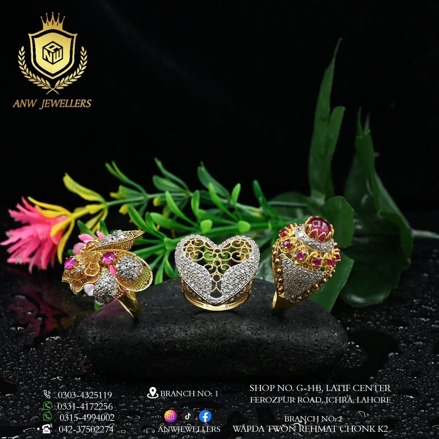 Three ornate gold rings with gemstones and diamond accents by ANW Jewellers on black stone