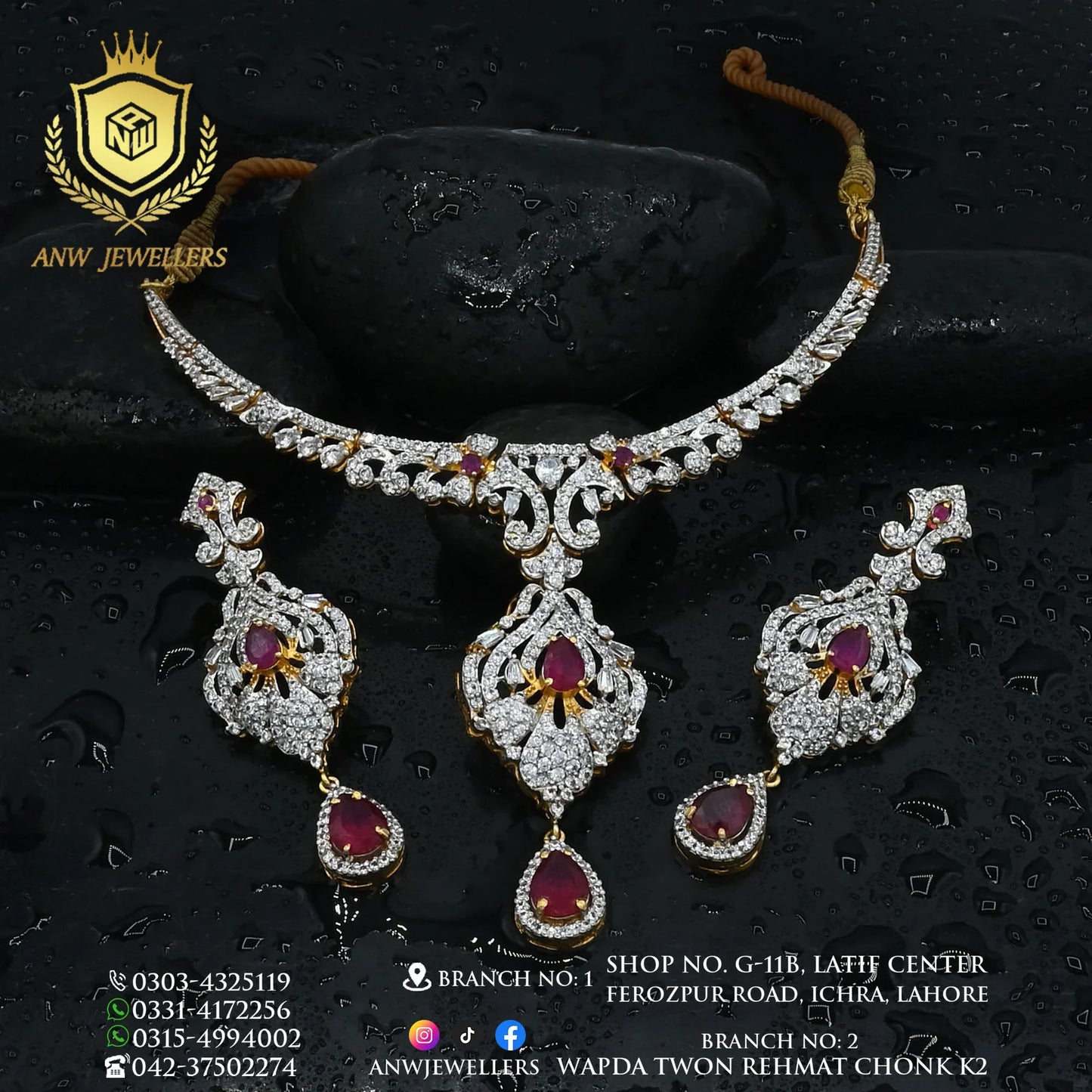 Gold and diamond jewelry set with ruby stones, necklace and earrings by ANW Jewellers on black stones.