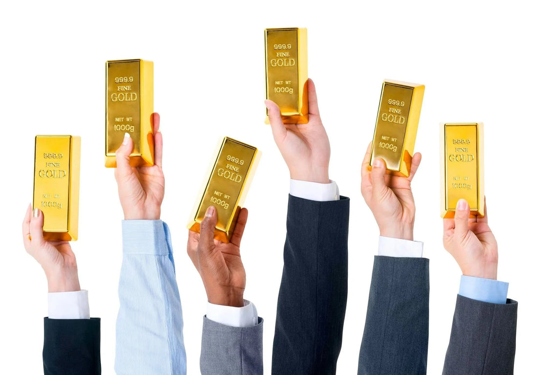 Businesspeople holding gold bars, investment concept on white background