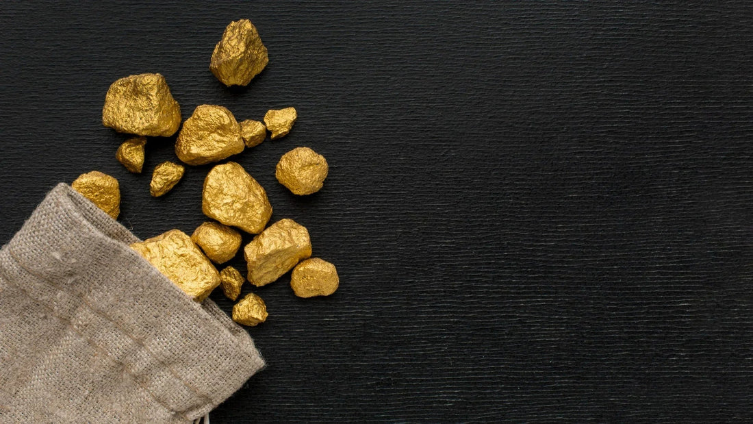 Raw gold nuggets spilling from burlap sack on black textured background
